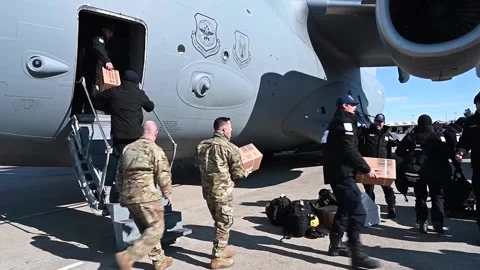 U.S. Air Force and Disaster Response off-load emergency supplies from C-17  Stock Footage 232681945