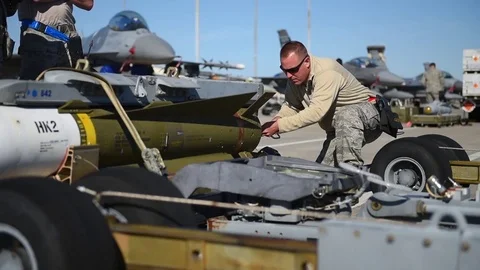 U.S. Air Force assembling weapon during building and loading program with F-16 Stock Footage 83307034