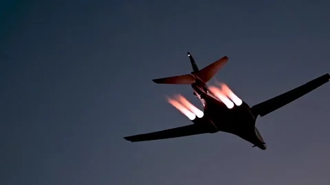 U.S. Air Force B-1B Lancer aircraft flying with afterburners at dusk Video stock 233255968