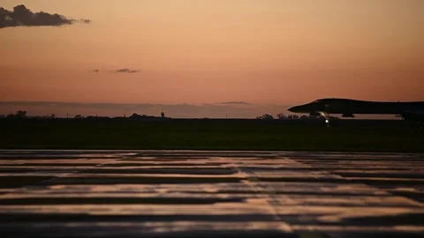 U.S. Air Force B-1B Lancer aircraft taxiing at sunset Video stock 272588161