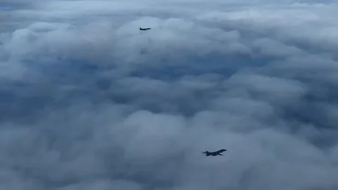 U.S. Air Force B-1B Lancer flying above the clouds with KC-135 Stratotanker Video stock 299797655