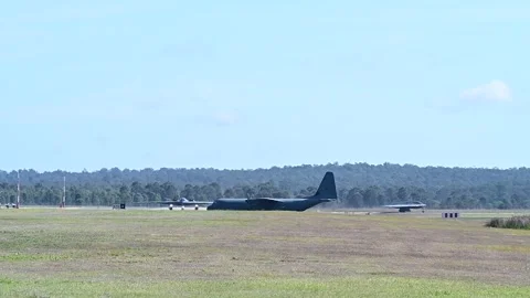 U.S. Air Force B-2 Spirit bombers and C-130 Hercules aircraft taxiing Stock Footage 282433911