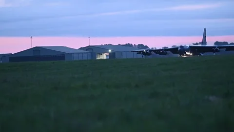 U.S. Air Force B-52 Stratofortress taxiing for take-off at dusk Stock Footage 277262500
