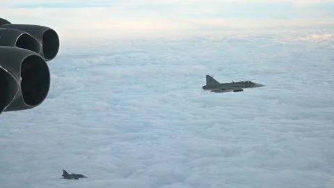 U.S. Air Force B-52 flying with two Swedish Air Force JAS 39 Gripen aircraft Stock Footage 294191590