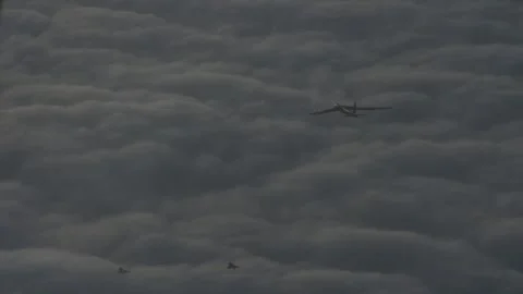 U.S. Air Force B-52 Stratofortress flying with a Saab JAS 39 Gripen above clouds Stock Footage 294522720
