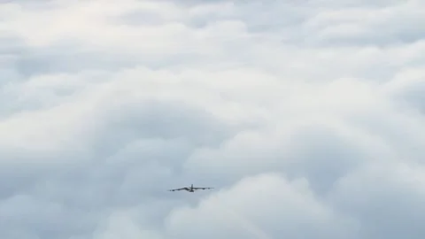 A U.S. Air Force B-52 Stratofortress leaving contrails as it flies above clouds Stock Footage 294522802