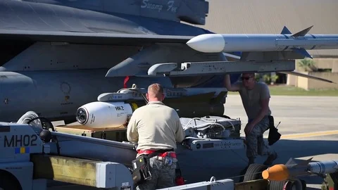 U.S. Air Force bomb loader loading munitions onto F-16 Stock Footage 83307210