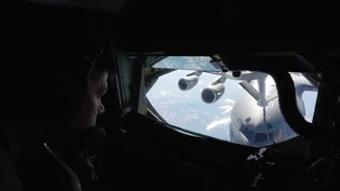 U.S. Air Force boom operator looking out of window at C-17 Globemaster III Stock Footage 256972113