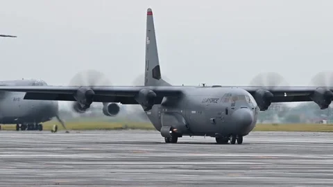 A U.S. Air Force C-130 Hercules taxis near a C-5 Galaxy Stock Footage 289283198