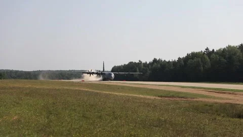U.S. Air Force C-130J Super Hercules landing on dirt runway. Stock Footage 283728875