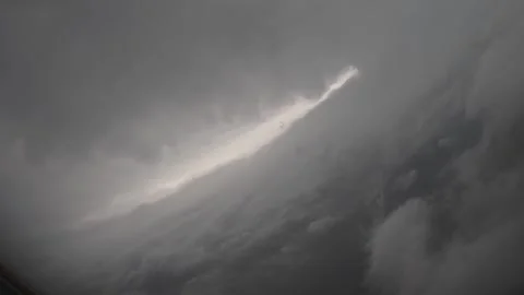 U.S. Air Force C-130J Super Hercules flying through the eye of Hurricane Milton Stock Footage 287996313