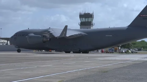 U.S. Air Force C-17 Globemaster aircraft taxiing near control tower Stock Footage 260883978