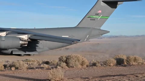U.S. Air Force C-17 Globemaster III accelerating for take off from desert runway Stock Footage 294679859