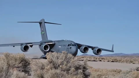U.S. Air Force C-17 Globemaster III aircraft taxiing after landing in desert Stock Footage 294679965