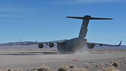 U.S. Air Force C-17 Globemaster III aircraft turning on runway in the desert Stock Footage 294679976