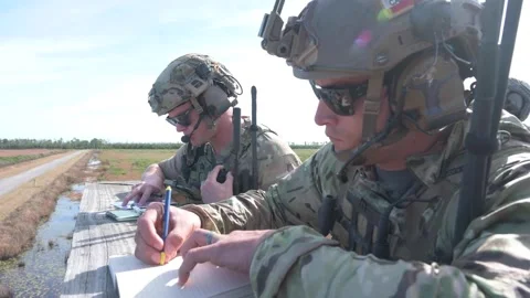 U.S. Air Force close air support specialists writing in notebook during exercise Stock Footage 256293075