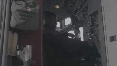U.S. Air Force E-8 Joint STARS flight engineer adjusting controls on panel Video stock 260385448
