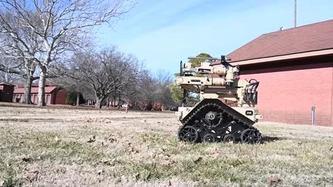 U.S. Air Force EOD T7 Talon multi-mission robotic system moving across grass Stock Footage 300439873