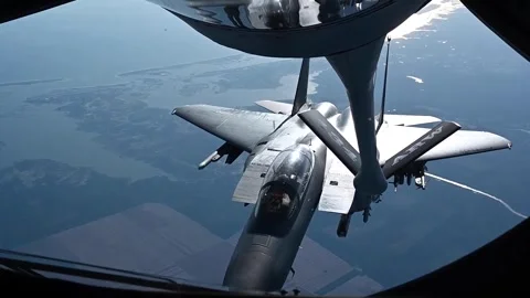U.S. Air Force F-15E Strike Eagle approaching KC-135 boom for aerial refueling Stock Footage 295033699