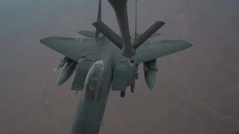 U.S. Air Force F-15E Strike Eagle aerial refueling mission above desert Stock Footage 297066673