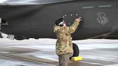 U.S. Air Force ground crew closes and secures flap on F-35A Lightning II Stock Footage 254779782