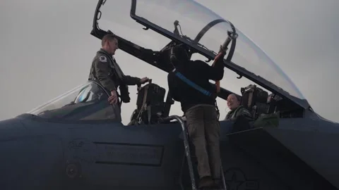 U.S. Air Force ground crew attaches red tag to canopy of F-15E Strike Eagle Stock Footage 254780616