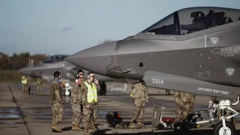 U.S. Air Force ground crew speaking to F-35A pilot during hot pit refuel Stock Footage 256212126