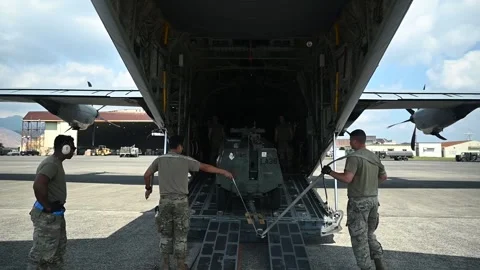 U.S. Air Force groundcrew loading equipment onto C-130J Hercules aircraft Stock Footage 255203995