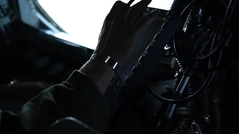U.S. Air Force KC-135 boom operator inputting data into on-board computer keypad Stock Footage 274193326