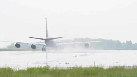 U.S. Air Force KC-135 Stratotanker taxiing on wet runway during rainfall Stock Footage 276089302