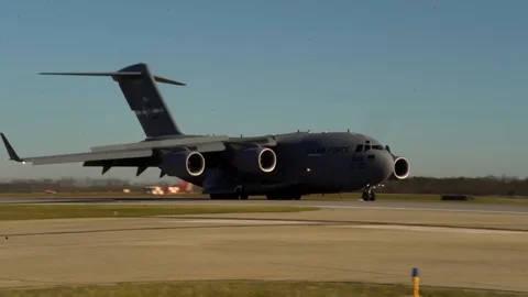 US Air Force military cargo aircraft landing on military base Stock Footage