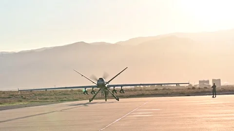 U.S. Air Force MQ-9 Reaper Unmanned Aerial Vehicle taxiing at sunrise Stock Footage 254066707