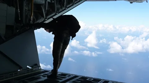 U.S. Air Force parachutist looking out from rear of MC-130J Commando II aircraft Stock Footage 258335768