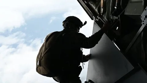 U.S. Air Force pararescueman looking out from ramp of MC-130J Commando II  Видео 262530564