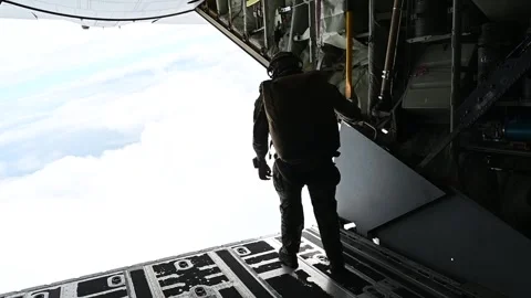 U.S. Air Force pararescueman looking out from MC-130J Commando II during flight Stock Footage 262530592