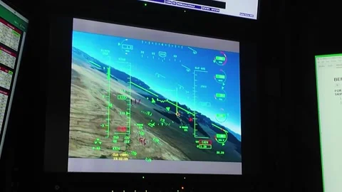 U.S. Air Force personnel remotely flying MQ-9 Reaper UAV from operations center Stock Footage 292972002