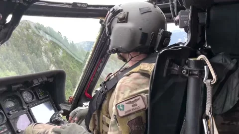 U.S. Air Force pilot flying through Dolomite Mountains in HH-60 Pave Hawk  Stock Footage 213581051