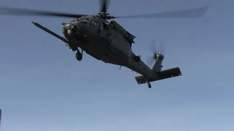 U.S. Air Force pilot HH-60G Pave Hawk helicopter flying overhead Stock Footage 257666453