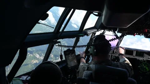 U.S. Air Force pilot pointing at scenery while flying MC-130J Commando II Stock Footage 258335692