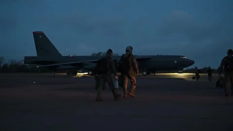 U.S. Air Force pilots and crew approaching B-52 Stratofortress at dusk Stock Footage 294522832