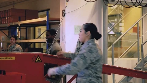 U.S. Air Force post office workers collecting packages from conveyor Stock Footage 103582173