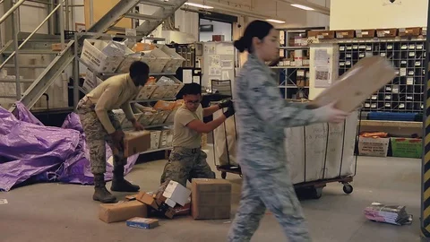 U.S. Air Force post office workers loading mail trolley with packages Stock-Footage 103582187