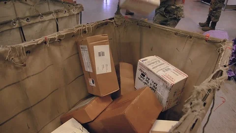 U.S. Air Force post office workers loading packages into mail trolley Stock Footage 103582208
