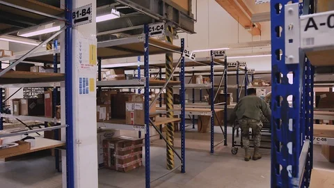 U.S. Air Force post office workers dragging conveyor over floor 動画素材 103586289