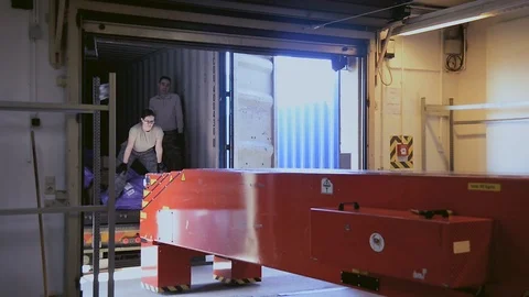 U.S. Air Force post office workers pushing conveyor towards delivery truck Видео 103586317