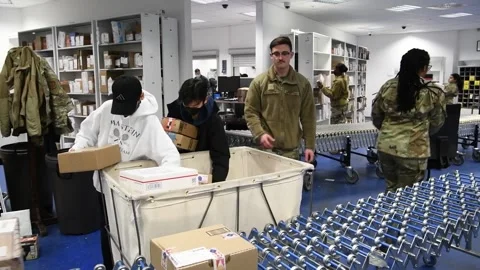 U.S. Air Force postal staff unload packages from mail trolley Stock Footage 168292847