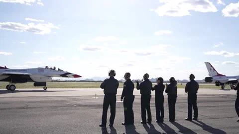 U.S. Air Force Thunderbirds demonstration team maintainers waving at aircraft Stock Footage 257413928