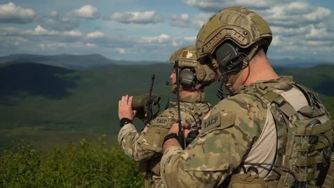 U.S. airman looking through binoculars during close air support exercise Stock Footage 110732477