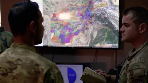 U.S. airman takes notes during mission planning at Afghan command center Stock Footage 94367787