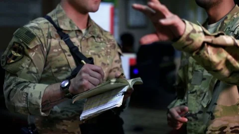 U.S. airman takes notes during mission planning at Afghan command center Видео 94367799